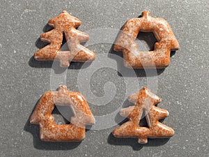 Christmas gingerbread in the shape of a Christmas tree on a stone background