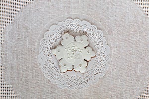 Christmas gingerbread snowflake on a background of napkin. Christmas toy gingerbread cookie, decorated with Icing. New