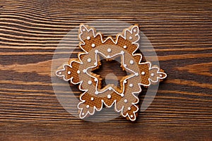 Christmas gingerbread snowflake on wooden texture