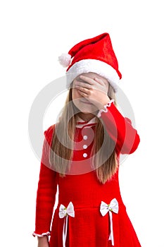 Christmas girl with closed the eyes with her hand, wearing a santa hat isolated over a white background