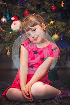 Christmas girl in front of Christmas tree