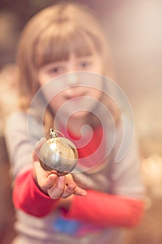 Christmas girl holding decorating bauble