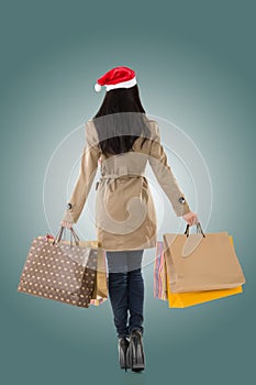 Christmas girl holding shopping bags