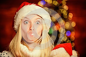 Christmas girl made bubble bubblegum. Crazy grimace. Blow Bubbles with Gum. Only fun on my mind. Girl Santa claus making