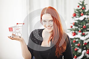 Christmas girl with mini shopping trolly cart