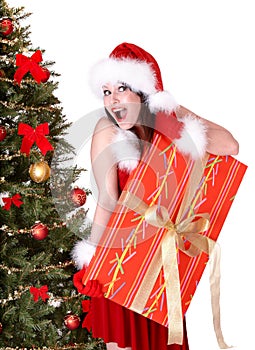 Christmas girl in santa hat and fir tree, gift box