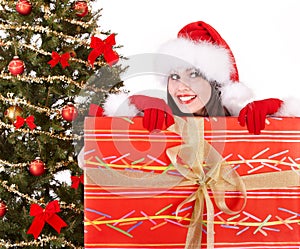 Christmas girl in santa hat, fir tree, gift box.