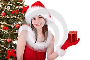 Christmas girl in santa hat with small gift box.