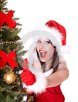 Christmas girl in santa hat with thumb up.