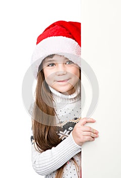 Christmas girl in santa helper hat with blank white board. isolated