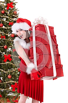 Christmas girl in santa holding stack gift box.