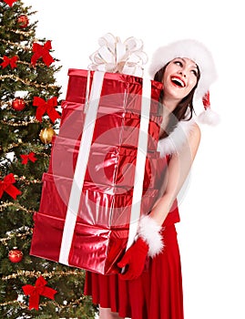Christmas girl in santa holding stack gift box.