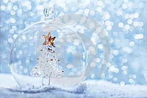 Christmas glass ball with crystal tree inside in snow