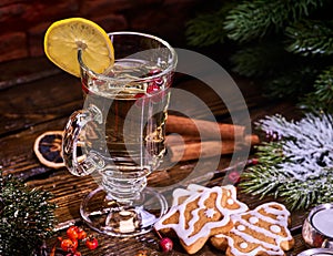 Christmas glass latte mug with lemon and red berry cookies .