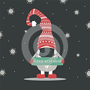 Christmas gnome wearing a protective face mask against coronavirus. New year greeting card with quote Merry and Safe.