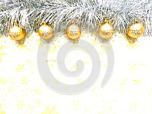 Christmas gold balls and silver garland on white background with yellow snowflakes photo