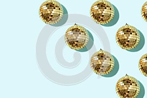 Christmas gold baubles organized on blue background. Top view. Flat lay. Creative New year pattern. Party time concept