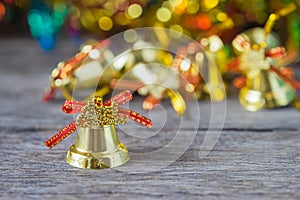 Christmas gold bells with bokeh decorations background.