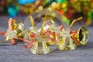 Christmas gold bells with bokeh decorations background.