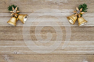 Christmas gold bells with grunge wood background