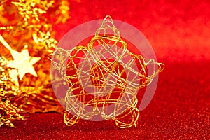 Christmas gold wire star on red glitter
