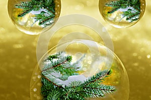 Christmas golden background with glittering snowflakes and fir branches in baubles