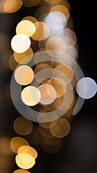 Christmas golden background. Golden holiday glowing background. Defocused background with a twinkling star. Blurred bokeh curtain
