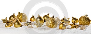 Christmas golden baubles on snow