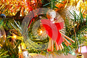 Christmas golden lights and Christmas balls and decoration detail, Wooden angels with red bows