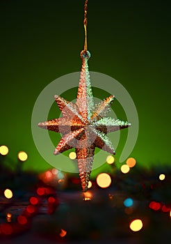 Christmas golden star ornament with Christmas lights atmosphere