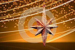 Christmas golden star ornament with traces and lights effect