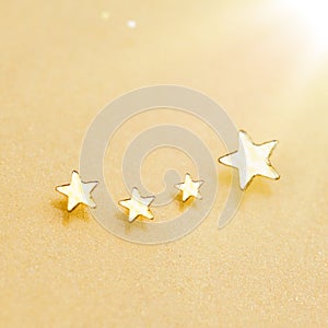 Christmas Golden Stars on Shiny Gold Background. Festive sparkling lights. Sparkling Falling Stars With Stardust Trail