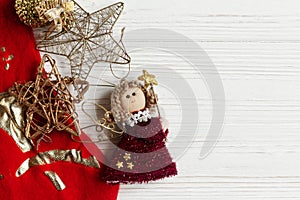 Christmas golden toys and red stockings on white rustic wooden b