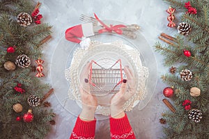 Christmas gray grunge background, fir twigs, berries, snowflakes, baubles, top view.