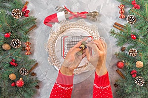 Christmas gray grunge background, fir twigs, berries, snowflakes, baubles, top view.