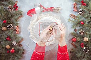 Christmas gray grunge background, fir twigs, berries, snowflakes, baubles, top view.