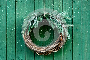 Christmas green decoration on the wooden background, natural festive wreath