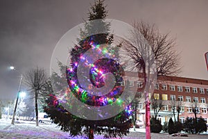 Christmas green tree with colorful lights, garlands