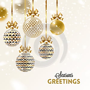 Christmas greeting card. Christmas baubles hang on golden ribbon