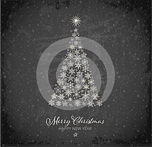 Christmas greeting card with christmas tree and snowflakes on blackboard background. Design template with winter