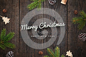 Christmas greeting card with decorations on dark wooden table