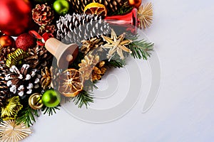 Christmas greeting card with fir branches and wooden jingle bell