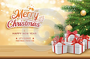 Christmas greeting card with gifts boxes on wooden table and tree bokeh background. Xmas and happy new year.