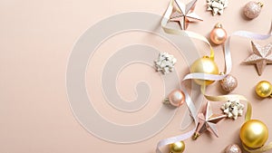 Christmas greeting card mockup with elegant decorations, gold Xmas balls, pink stars, ribbon on pastel ivory background. Happy New