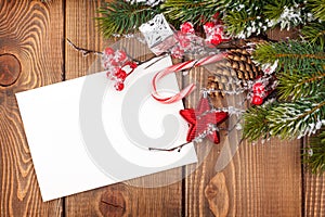 Christmas greeting card or photo frame over wooden table with sn