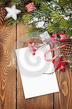 Christmas greeting card or photo frame over wooden table with sn