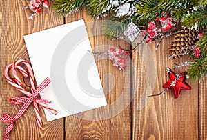 Christmas greeting card or photo frame over wooden table with sn