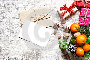 Christmas greeting card with tangerines, spices and nuts