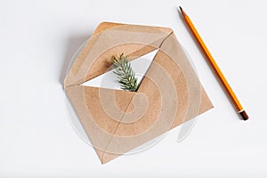 Christmas greeting craft envelope with holiday invitation or happy new year wish inside. Top view brown open envelope