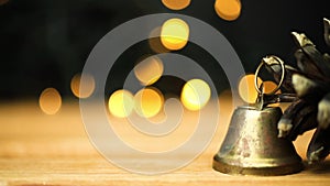 Christmas greetings background. Empty wooden table with decorations and copy space. Blurred christmas lights backdrop